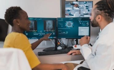 Two students review radiology scans at a computer