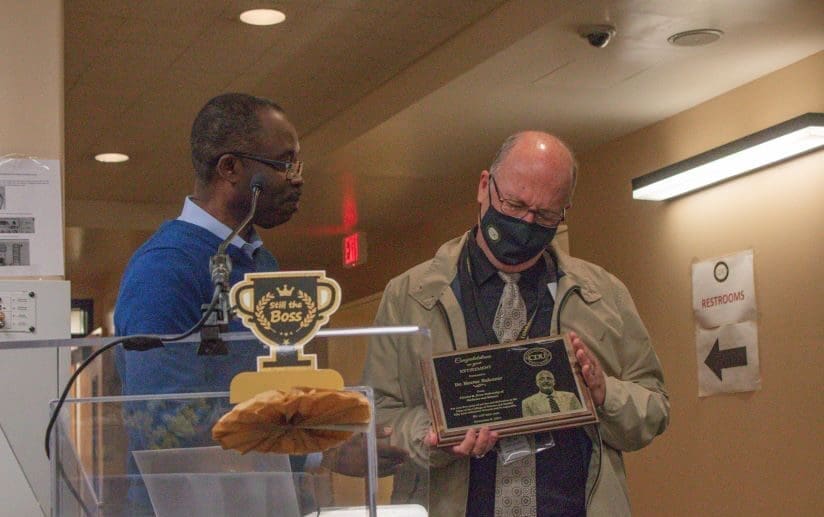 Former COSH Dean Dr. Hector Balcazar receives a plaque that commemorated his service to the University.