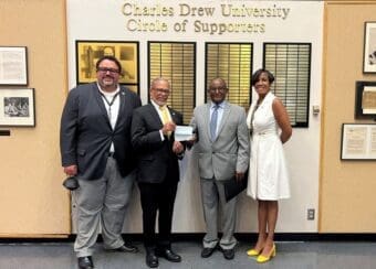 Kibebe Gizaw, McMillan-Stewart Foundation President, delivers two checks – $400,000 for scholarships and $200,000 for SSA II – to CDU staff.