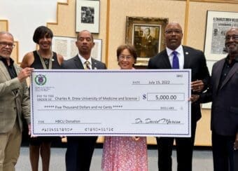 Group photo of the $5,000 check presentation from the Omega Psi Phi Fraternity, Inc.