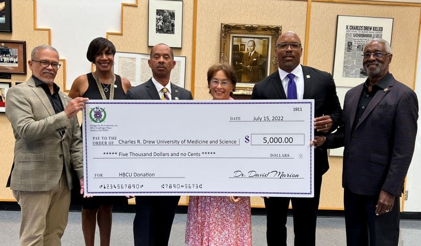 Group photo of the $5,000 check presentation from the Omega Psi Phi Fraternity, Inc.
