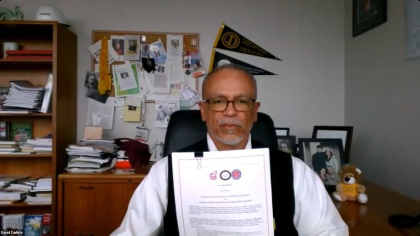 CDU President Dr. David Carlisle holds his signed Memorandum of Understanding the special Three-Year Bachelor Degree program.