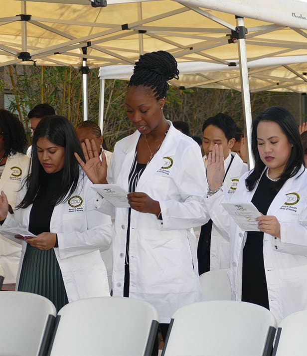 students reciting oath during white coat ceremony