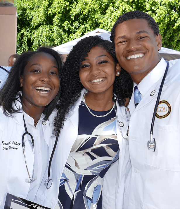 Three medical students after the college of medicine white coat ceremony