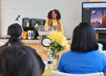 Adrienne Milbourne-Thompson, Academic Support Specialist, speaks at event