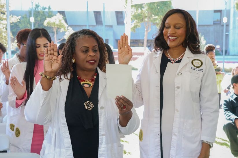 Two graduate nursing students during their oath