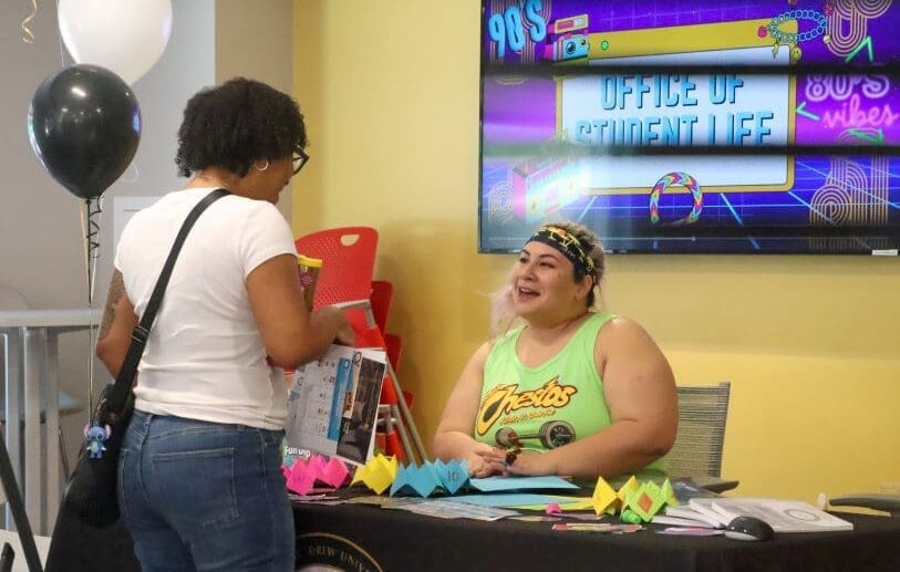 Student visits Office of 90s-themes Student Life booth at the 2024 Resource Fair