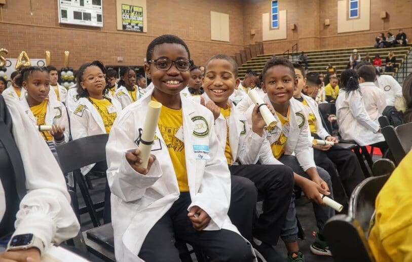 Elementary school students wear their white coats during the Junior White Coat Ceremony.