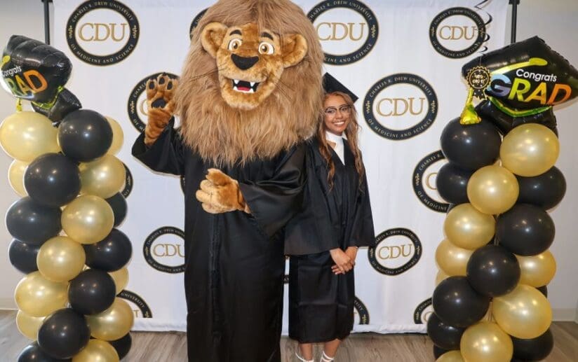 CDU student with Drew the Mascot during Gradfest 2024.
