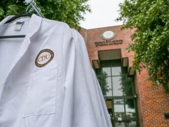 White coat in front of Cobb building