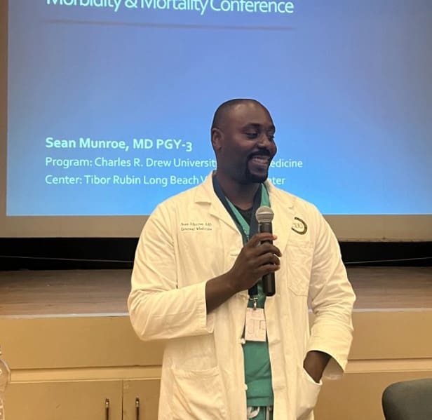 Black doctor in front of class
