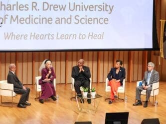 Dr. Carlisle and President's Breakfast panelists seated on stage