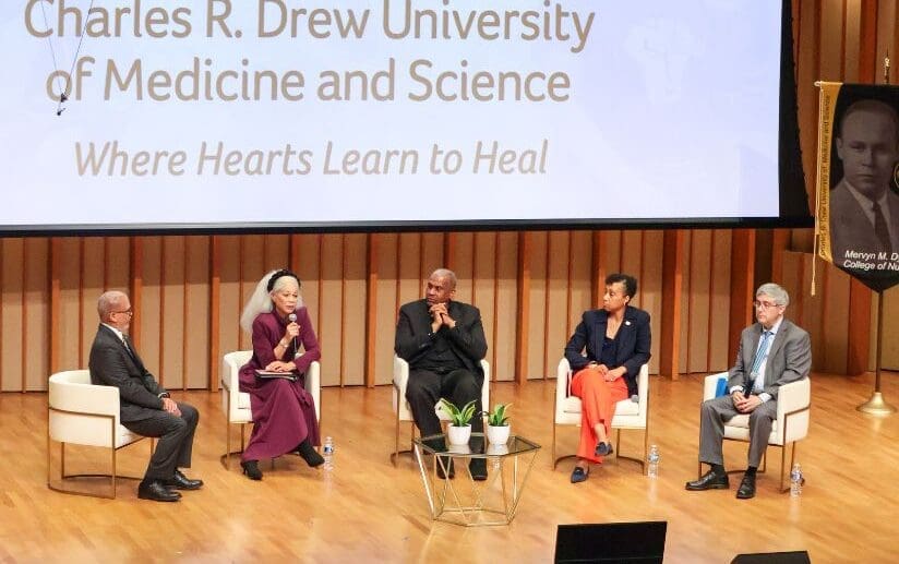 Dr. Carlisle and President's Breakfast panelists seated on stage