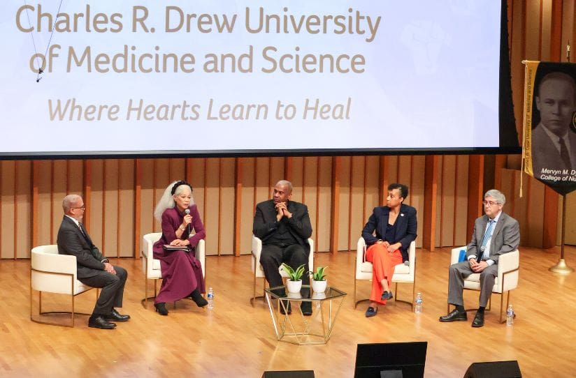 Dr. Carlisle and President's Breakfast panelists seated on stage