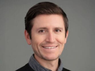 man wearing collared shirt and sweater