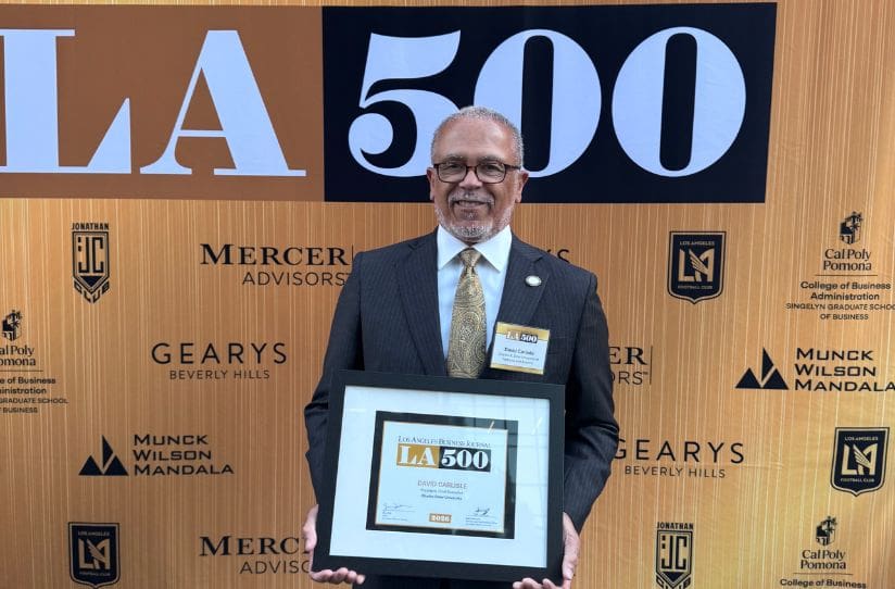 Dr. Carlisle holding LA500 plaque