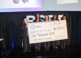 Students holding large check