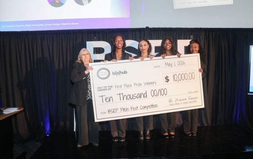 Students holding large check