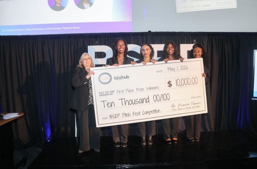 Students holding large check