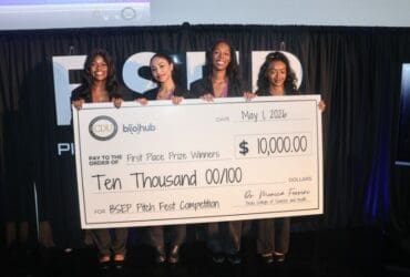 students holding large check