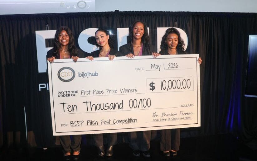 students holding large check