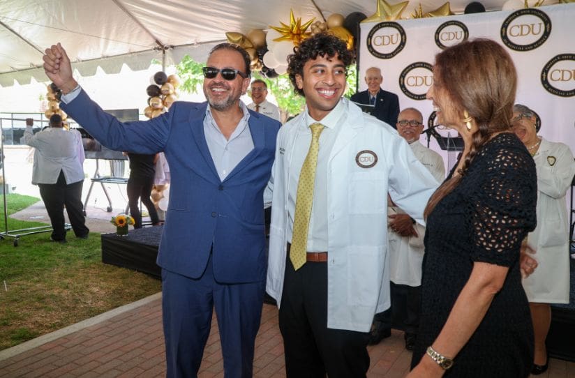  MD student smiling with white coat